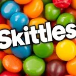 A colorful assortment of Skittles candies, showcasing original, tropical, and limited-edition flavors.