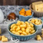 Various types of macaroni and cheese, from classic to creative recipes, showcasing different toppings, cheeses, and styles.