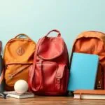 Author with various backpacks showcasing expertise in outdoor gear and travel packs.