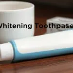 Close-up of a person smiling, showing bright white teeth after using whitening toothpaste.